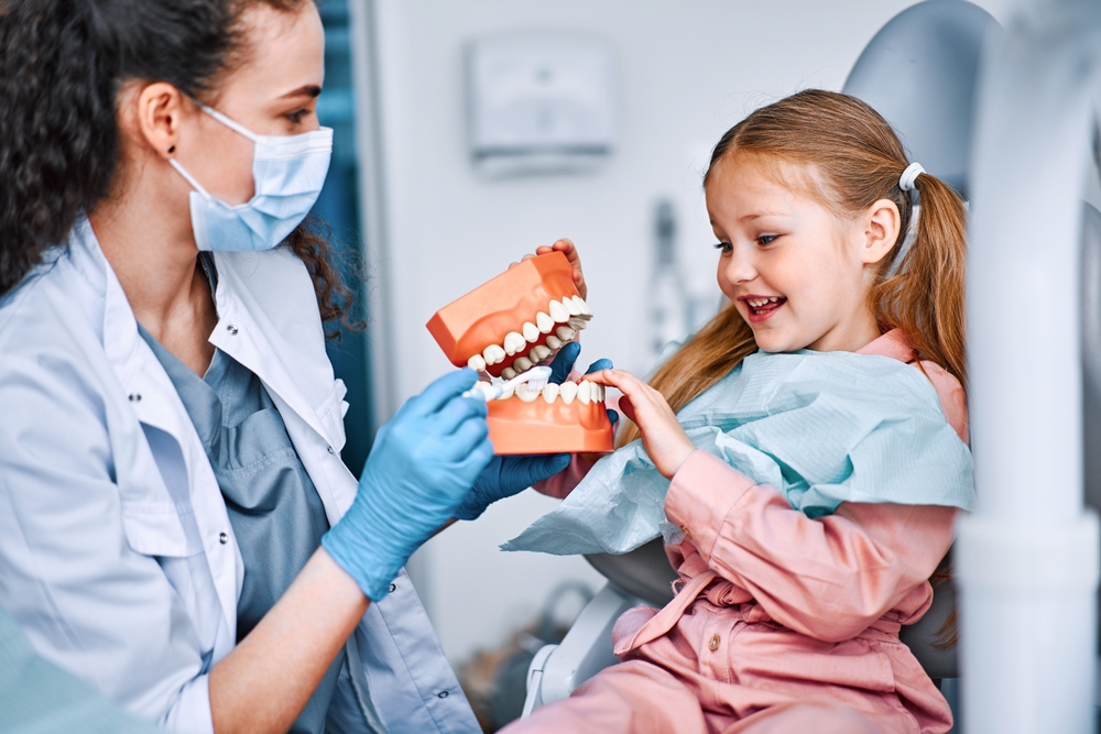 Happy Child Learning from Dentist