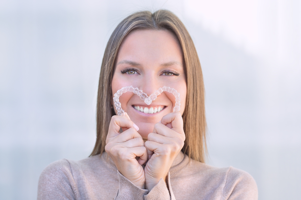 woman holding invisalign